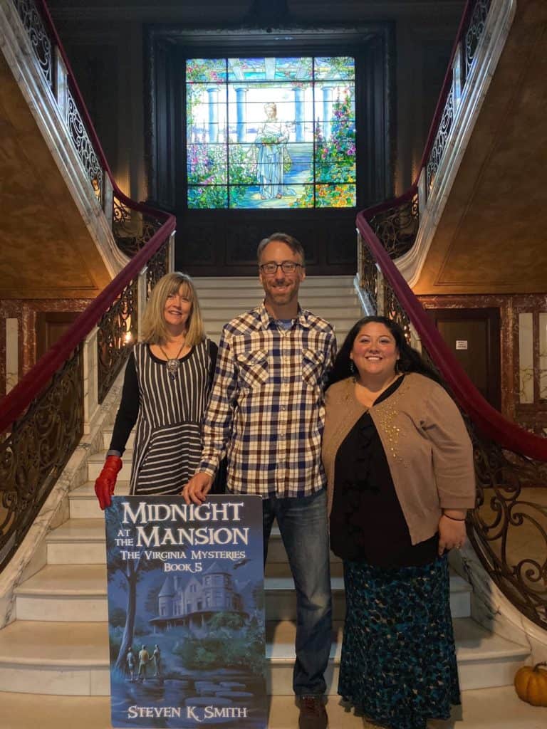 Steven K. Smith underneath the Sallie Dooley Tiffany window at Swannanoa