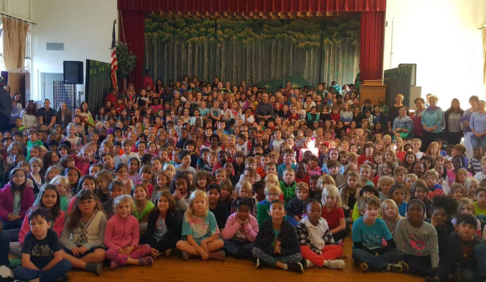 Steven speaking to a packed elementary school assembly